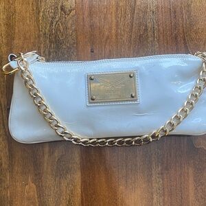 Guia’s Glossy White Clutch with Gold Chain